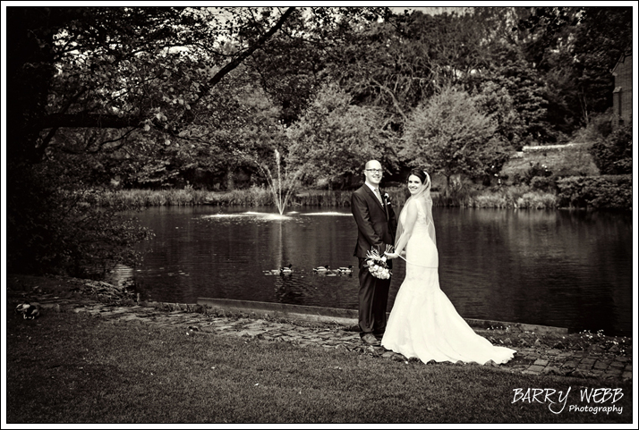 Bride and Groom pose infront of the lake
