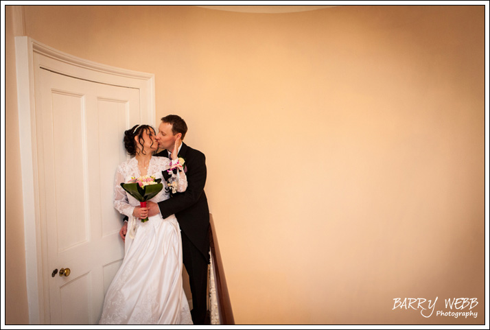 Kiss on the stairs at Hadlow Manor Hotel in Kent