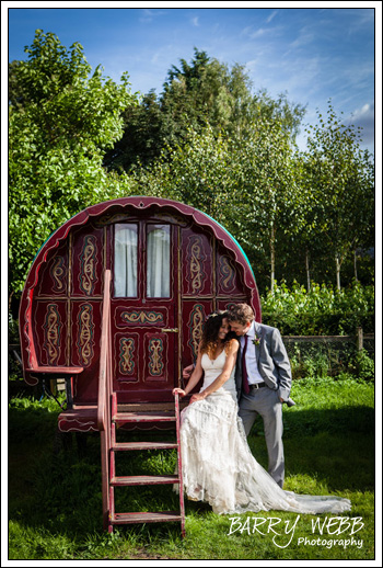 Bride and groom pose in front of gypsy caravan - South Farm in Hertfordshire - Wedding Photography