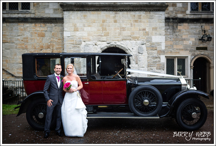 Bride and Groom pose infront of a classic car - Wedding at Archbishops Palace in Maidstone, Kent